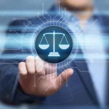 Digitalisierung in der Justiz | Bildquelle: Shutterstock Person im Hintergrund tippt auf einem Bildschirm die Justizwage an